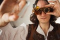 Steampunk style researcher mechanist of the monocle with a large number of lenses looking at something