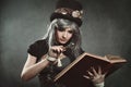 Steampunk woman with book and lens Royalty Free Stock Photo