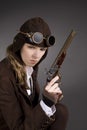 Steampunk woman wearing brown with aviator hat and gun Royalty Free Stock Photo