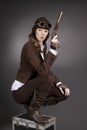 Steampunk woman wearing brown with aviator hat and gun Royalty Free Stock Photo