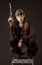 Steampunk woman wearing brown and holding a gun Royalty Free Stock Photo