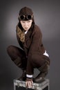 Steampunk woman wearing brown and kneeling down Royalty Free Stock Photo