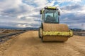 Steamroller performing leveling work on a road under construction