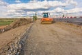 Steamroller performing road paving works