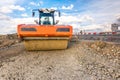 Steamroller performing road paving works