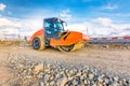 Steamroller performing road paving works