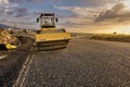 Steamroller performing road paving works