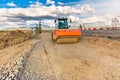 Steamroller performing road paving works