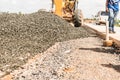 Steamroller spreading asphalt mixture during the construction of a road in Central America