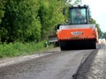 Steamrollers and road machinery working - laying asphalt