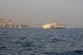 Steamship photographed during sunset at the sea in the Bosphorus. Behind the ship is the city of Istanbul. Royalty Free Stock Photo