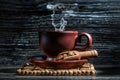 Steamy coffee cup and little wooden scoop