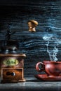 Steamy coffee cup and mill on vintage wood Royalty Free Stock Photo