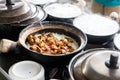 Steamy hot clay pot chicken rice being cooked in restaurant. Popular food in Malaysia