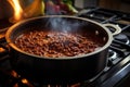 steamy pot of homemade chili on stovetop
