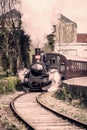 Steamy veteran train driving on a railway Royalty Free Stock Photo