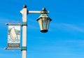 Stearn`s Wharf welcome banner with carriage lamp on metal pole Royalty Free Stock Photo