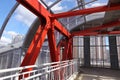 Steel beams in red against a blue sky. Overhead passage. Industrial background Royalty Free Stock Photo