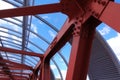 Steel beams in red against a blue sky. Overhead passage. Industrial background Royalty Free Stock Photo