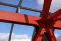 Steel beams in red against a blue sky. Overhead passage. Industrial background Royalty Free Stock Photo