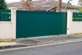 Steel big green metal gate fence on modern house street Royalty Free Stock Photo