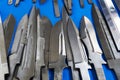 Steel blades of combat knives on a blue background. Close-up