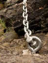Steel bolt anchor eye in hard basalt rock. End of steel chain Royalty Free Stock Photo