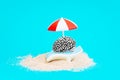 Steel brain relaxing under a sun umbrella by water Royalty Free Stock Photo