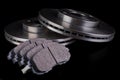 Steel brake discs and brake pads for a passenger car. New spare parts for car repairs