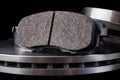 Steel brake discs and brake pads for a passenger car. New spare parts for car repairs