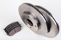 Steel brake discs and brake pads for a passenger car. New spare parts for car repairs