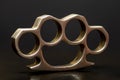 Steel brass knuckles on a black background with reflections. Concept: hooligan fight, fighting without rules, street banditry, inj