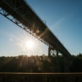 Steel Bridge Silhouette at Sunset with Bright Sunlight Rays Royalty Free Stock Photo