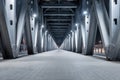 Steel bridge structure illuminated by cold white lights, creating a dramatic and empty atmosphere Royalty Free Stock Photo