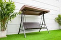 Steel brown swing chair modern style on white concrete background