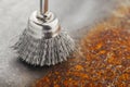 Steel brush for drill clean off old metal sheet with rust Royalty Free Stock Photo