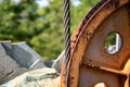 Steel cable and winch. Part of an old winch with a steel rope on a lift. Detail of the cableway. Close-up view of steel big wheel Royalty Free Stock Photo