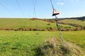 Steel cables at power electricity pylon with red warning triangles with exclamation mark - danger, high voltage, small Royalty Free Stock Photo