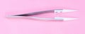 Steel Ceramic Tweezer on pink background