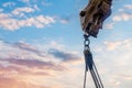 Steel chain attached to the excavator arm. Lifting gear against blue sky with space for text as an abstract industrial