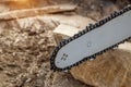 Steel chain chainsaw. sawing firewood outdoors Royalty Free Stock Photo