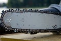 Steel chain chainsaw. sawing firewood outdoors Royalty Free Stock Photo
