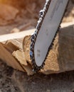Steel chain chainsaw. sawing firewood outdoors Royalty Free Stock Photo