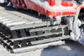 Close up of the chain of a snowcat high up in the mountains in the Sierra Nevada winter sports resort.