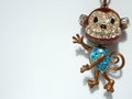 Bronze metal monkey primate keychain colored with blue and white color rhinestones Royalty Free Stock Photo