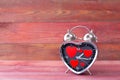 Steel clock alarm in the form of a heart, with a red hearts on a pink wooden background. Valentine`s Day Royalty Free Stock Photo
