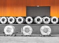 Steel coils on wooden pallets in warehouse stuffing area for container stuffing. Royalty Free Stock Photo