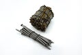 Steel construction nails of different lengths tied together in groups Royalty Free Stock Photo