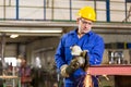 Steel construction worker cutting metal with angle grinder Royalty Free Stock Photo