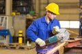 Steel construction worker cutting metal with angle grinder